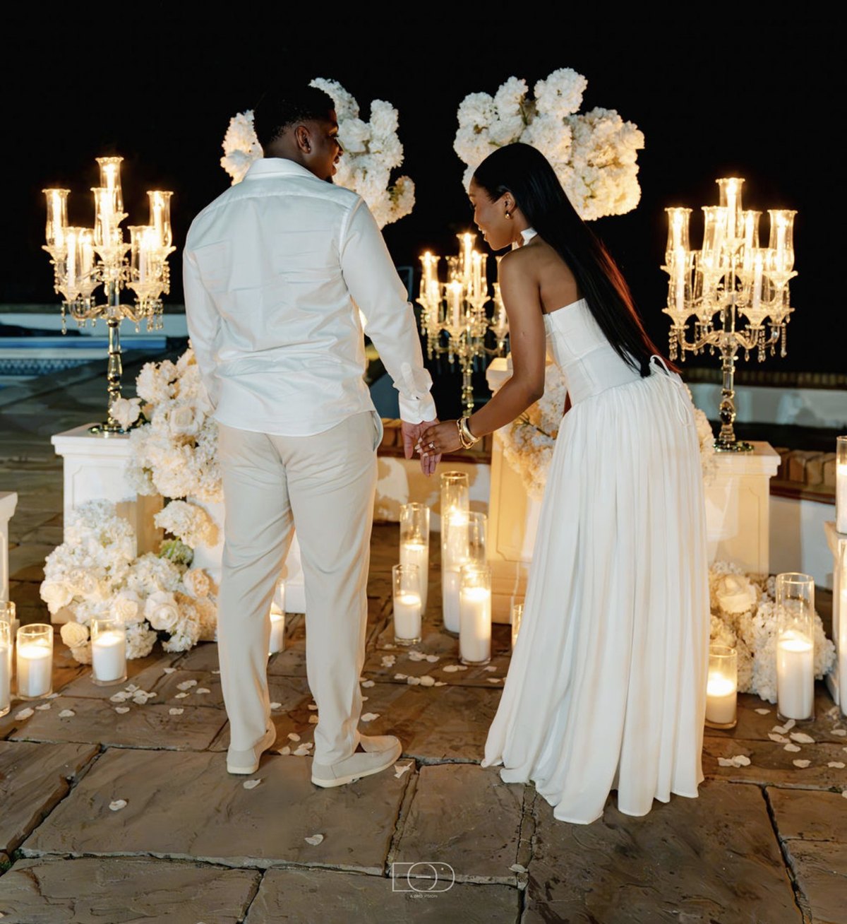 Walking hand in hand towards the candles