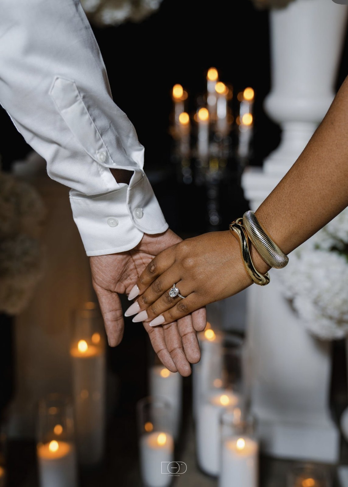 Hand in hand, the ring by candlelight